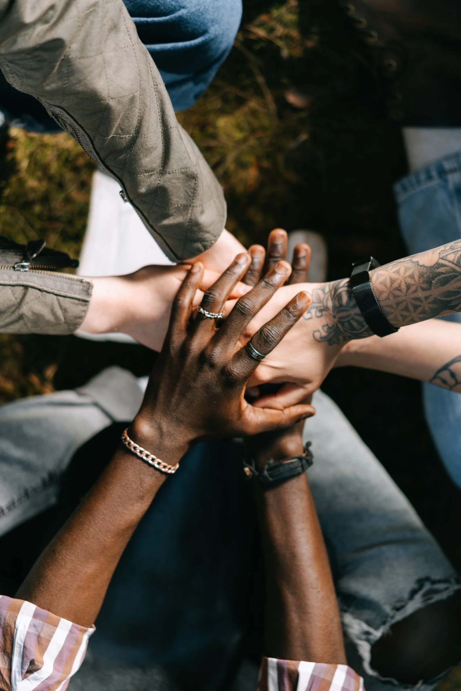 Diverse hands joined together in community solidarity